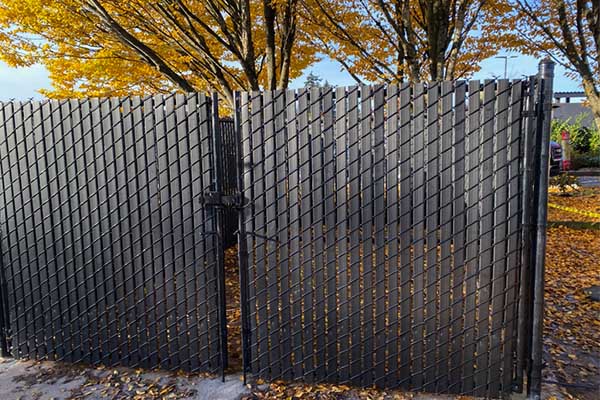 black chain link fence with black slats